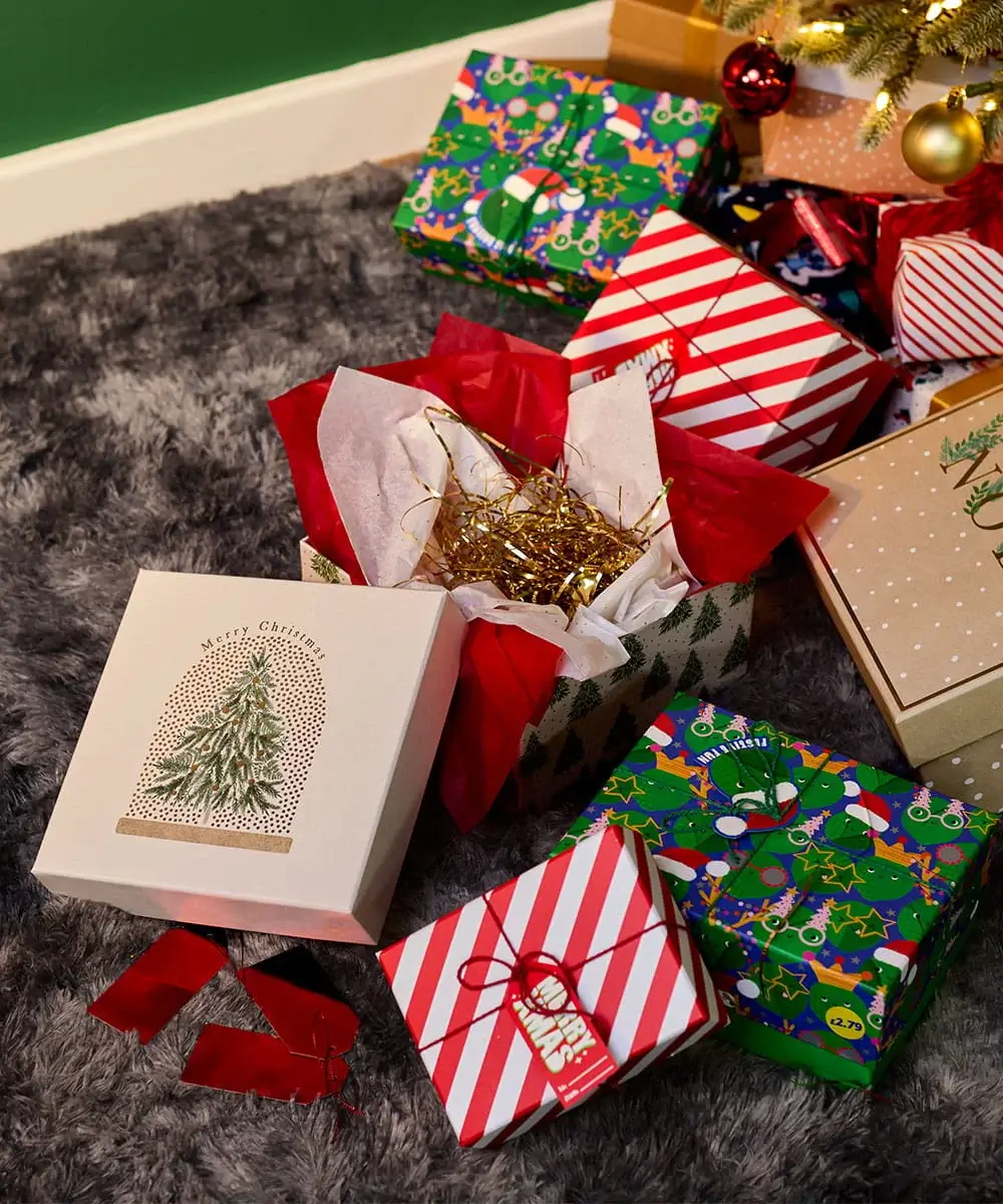 Christmas gift boxes and wrapped presents arranged beneath a decorated Christmas tree with festive packaging and seasonal decorations. Christmas gift boxes and wrapped presents arranged beneath a decorated Christmas tree with festive packaging and seasonal decorations.